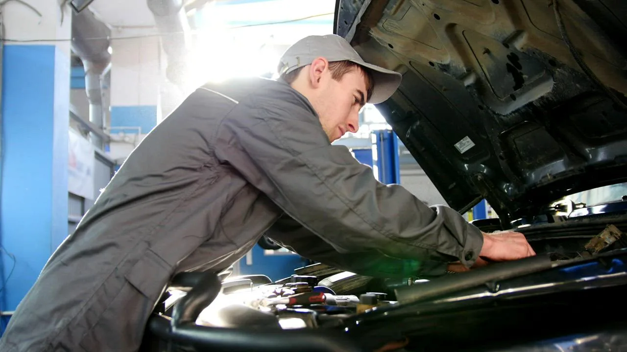 Mechanic checking the engine bay while diagnosing a heating problem